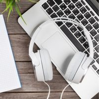 Headphones resting on a laptop