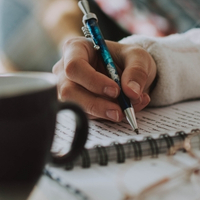 Someone taking notes as part of online therapy