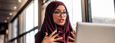 A woman gesturing while she discusses EMDR therapy online with her therapist