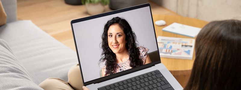 Best online therapist in Florida and Arizona Marisa Knight on a telehealth counseling session with a woman relaxed on her couch at home